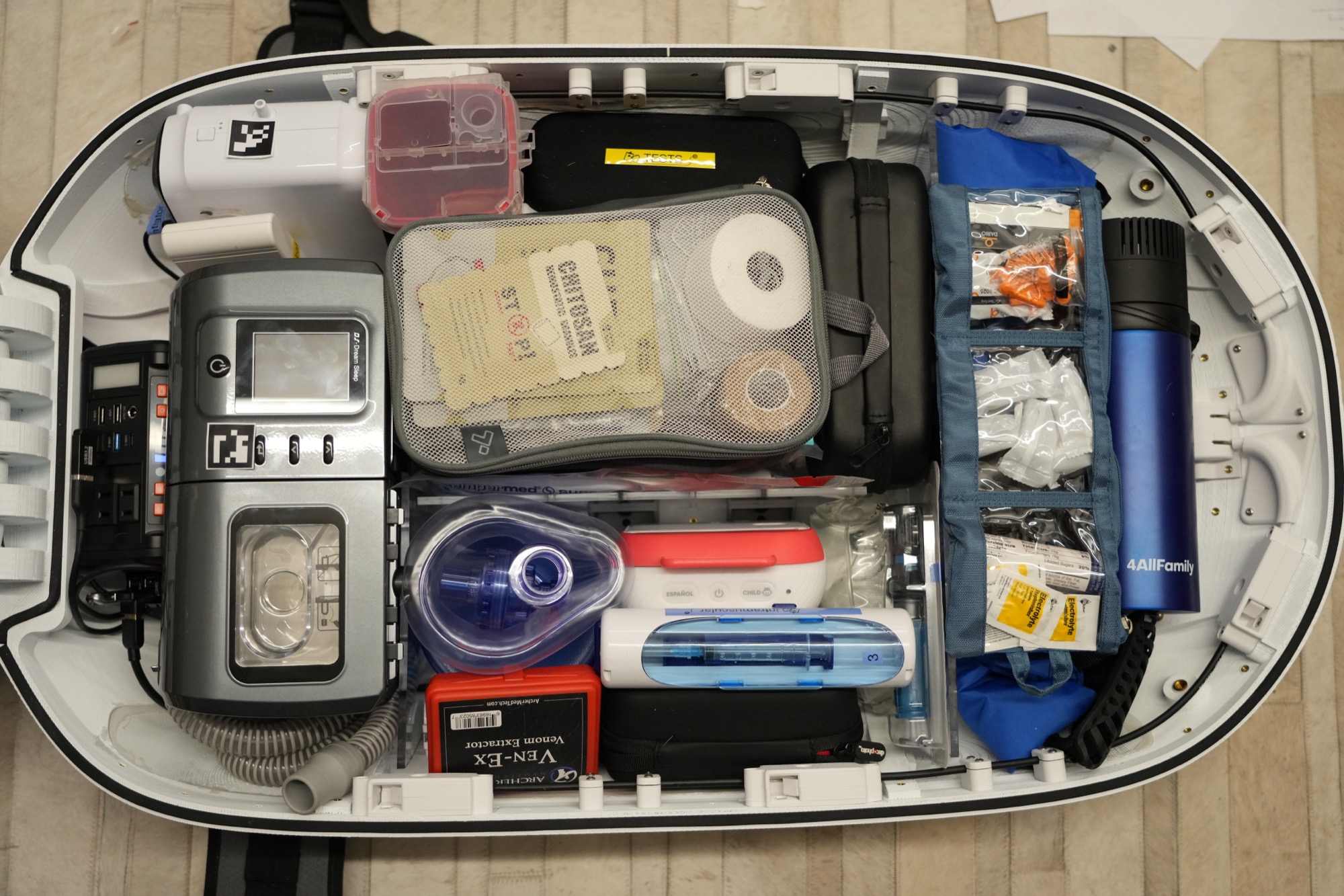 A packed travel medical kit holding diabetes and health monitoring supplies.